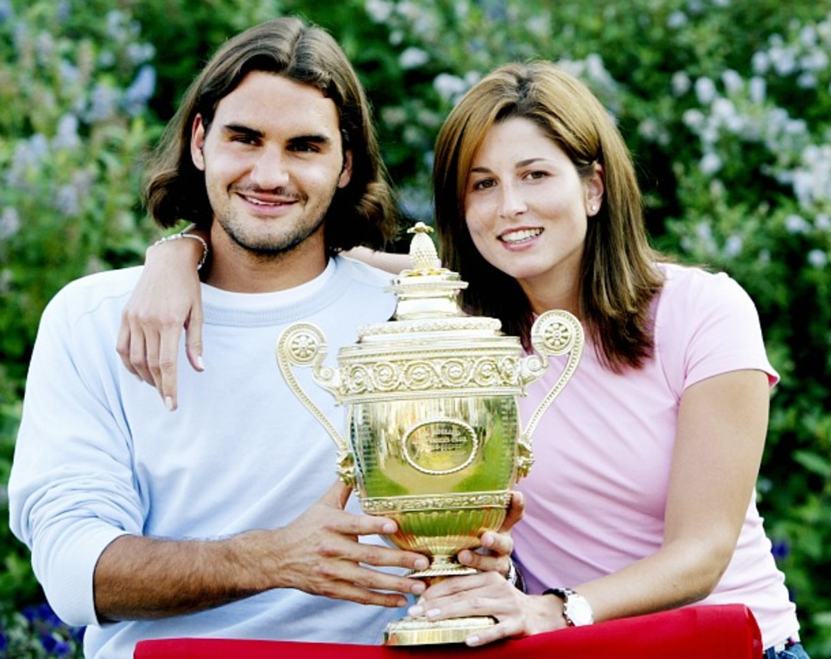 Roger and Mirka pose with his maiden Slam trophy at Wimbledon in 2003. (Cynthia Lum/WireImage/Getty Images)