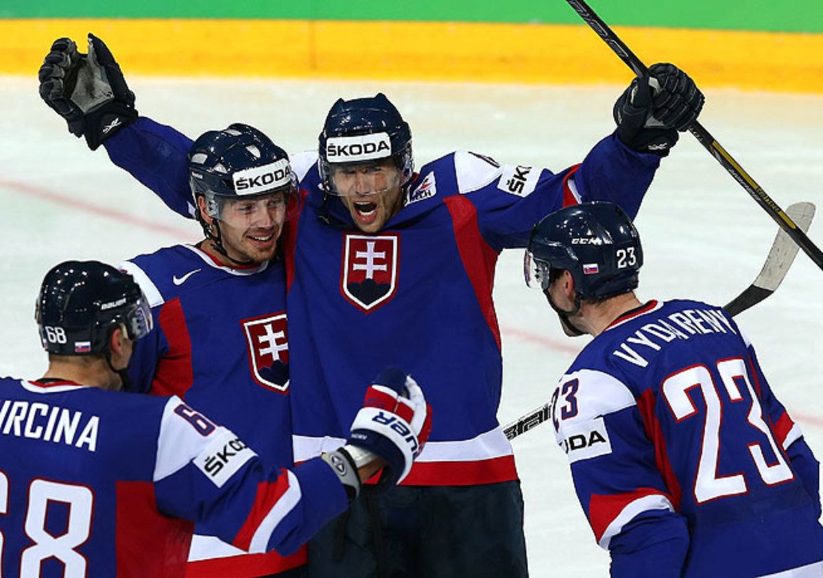 Roman Kukumberg (arms raised) celebrates with his teammates after Slovakia's third goal.