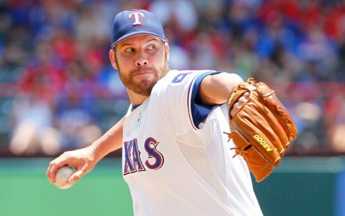 Colby Lewis' rehabilitation was cut short by surgery to remove bone spurs. (R. Yeatts/Getty Images)