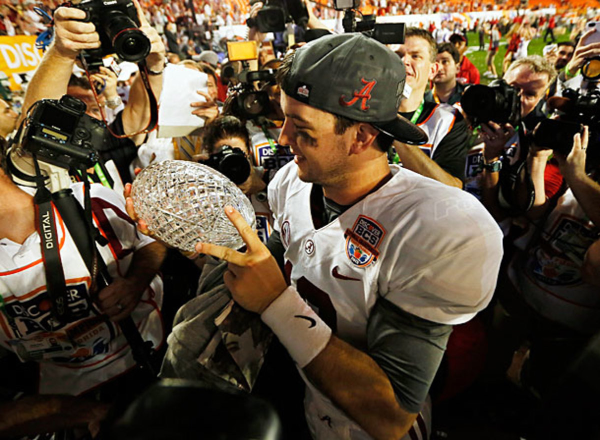 AJ McCarron meticulously examines 'Bama's latest BCS trophy for any cracks. (Kevin C. Cox/Getty Images)