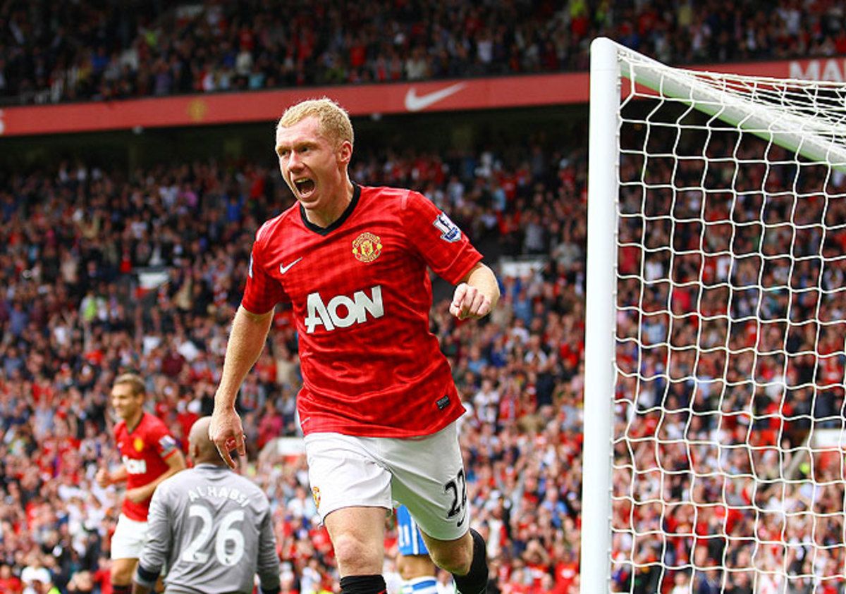 Paul Scholes, seen here after scoring against Wigan, has spent his whole career at Manchester United.