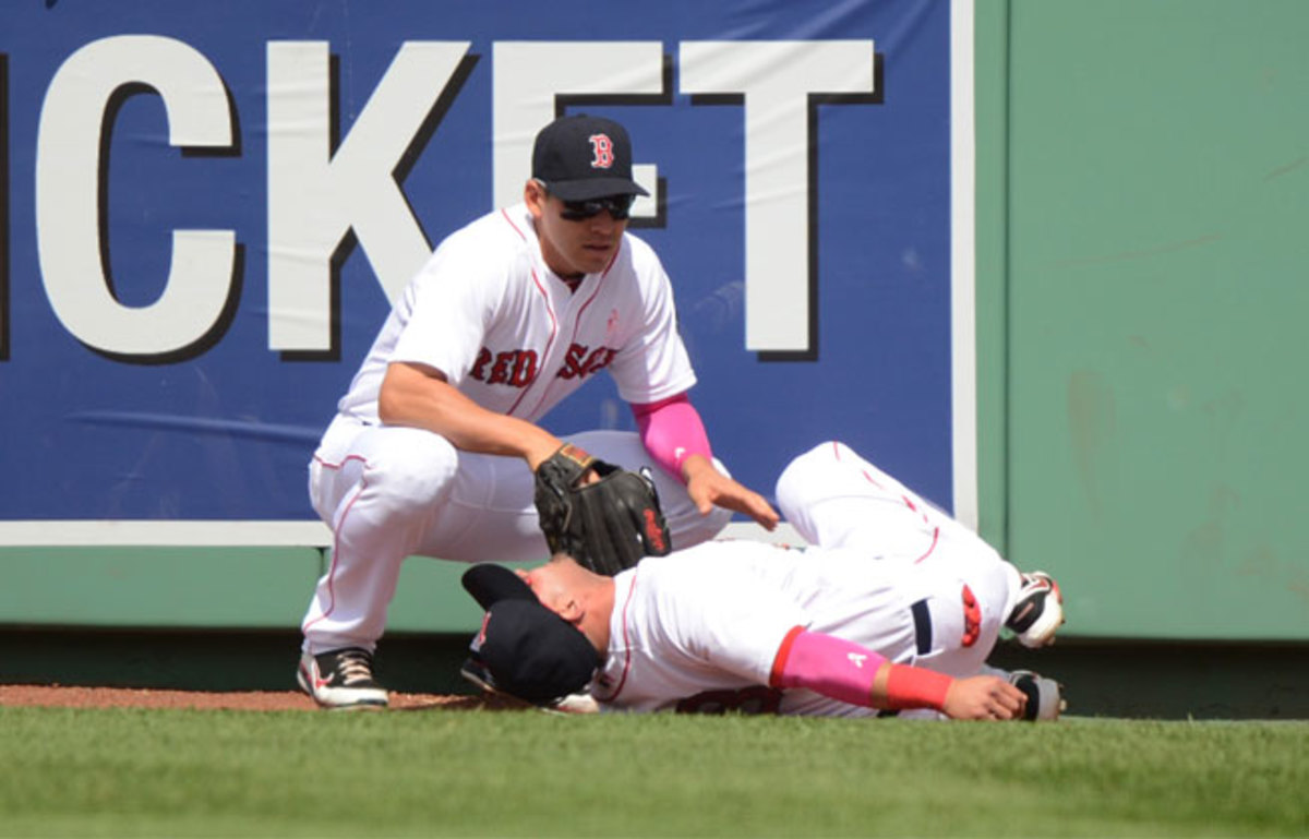 Shane Victorino ran hard into the low wall at Fenway Park while pursuing a home run Sunday.