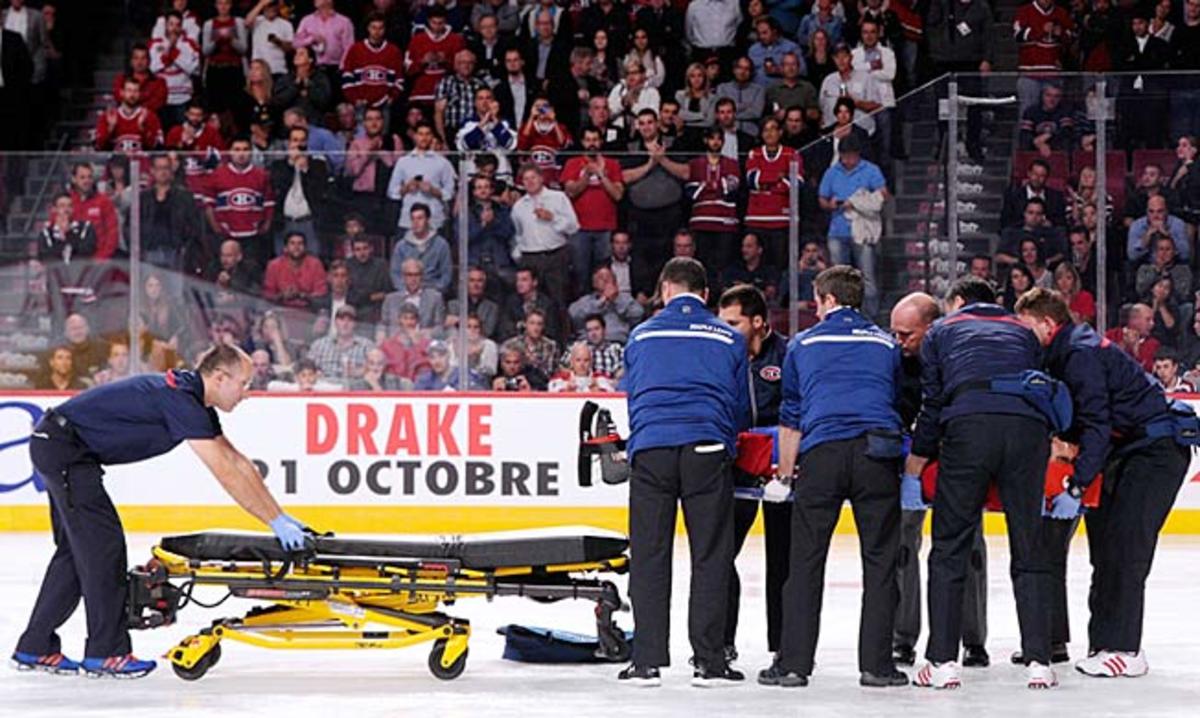 George Parros of the Montreal Canadiens is loaded onto a stretcher.