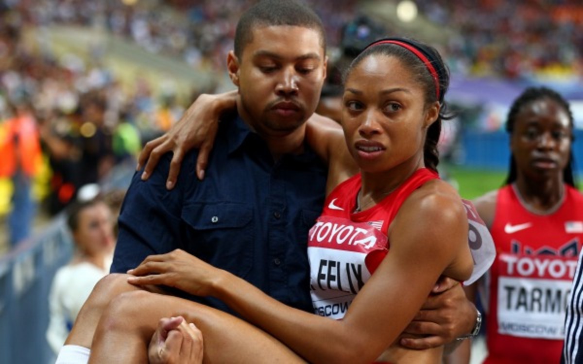 Allyson Felix is carried off the track by her brother Wes after tearing a hamstring in the 200 meter final. (Getty Images)
