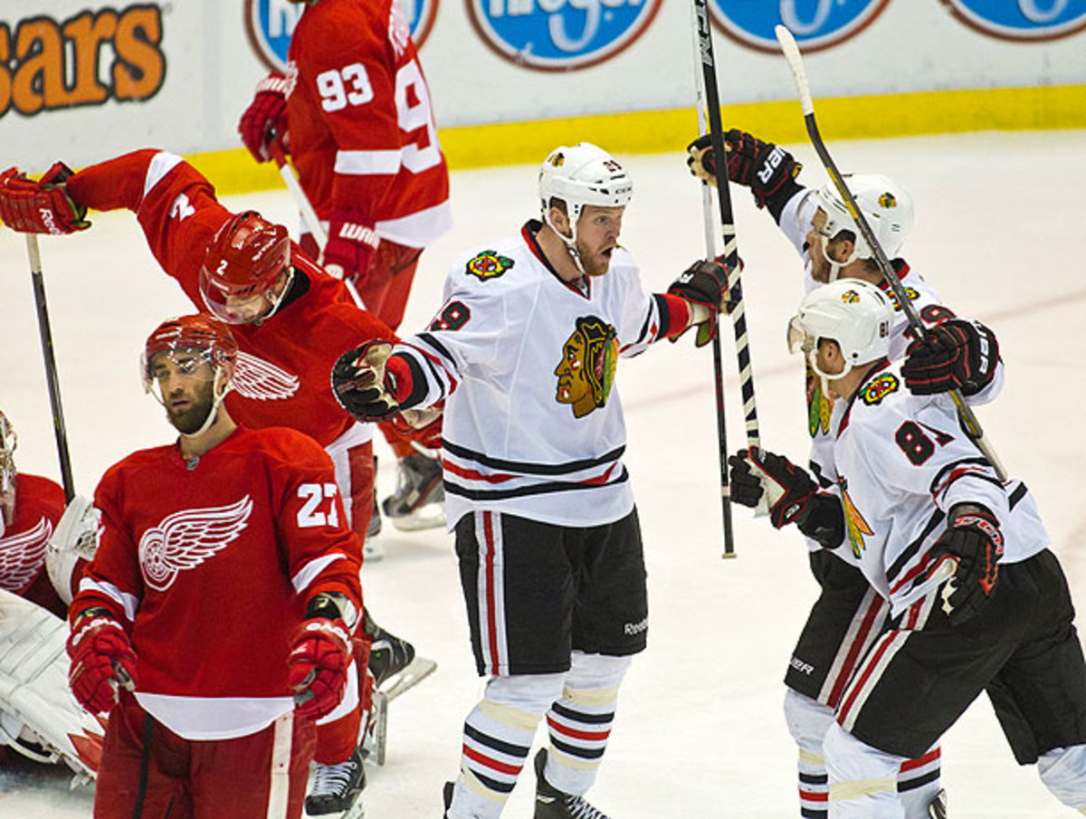 Bryan Bickell (center) scored a key goal after being moved up to Chicago's first line. (Tony Ding/Icon SMI)
