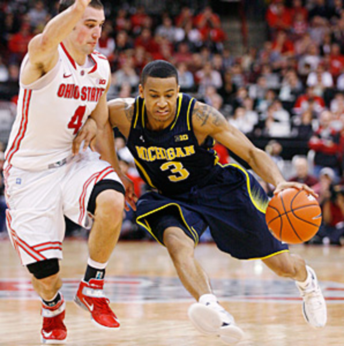 Trey Burke (3) battled with Ohio State's Aaron Craft (left) all day in Columbus.