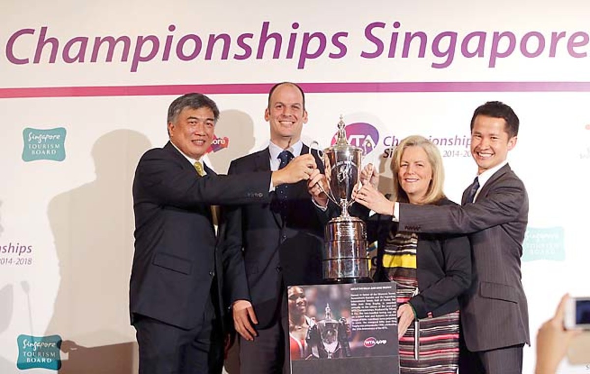WTA and Singapore executives pose with a masters trophy replica during Wednesday's press conference.