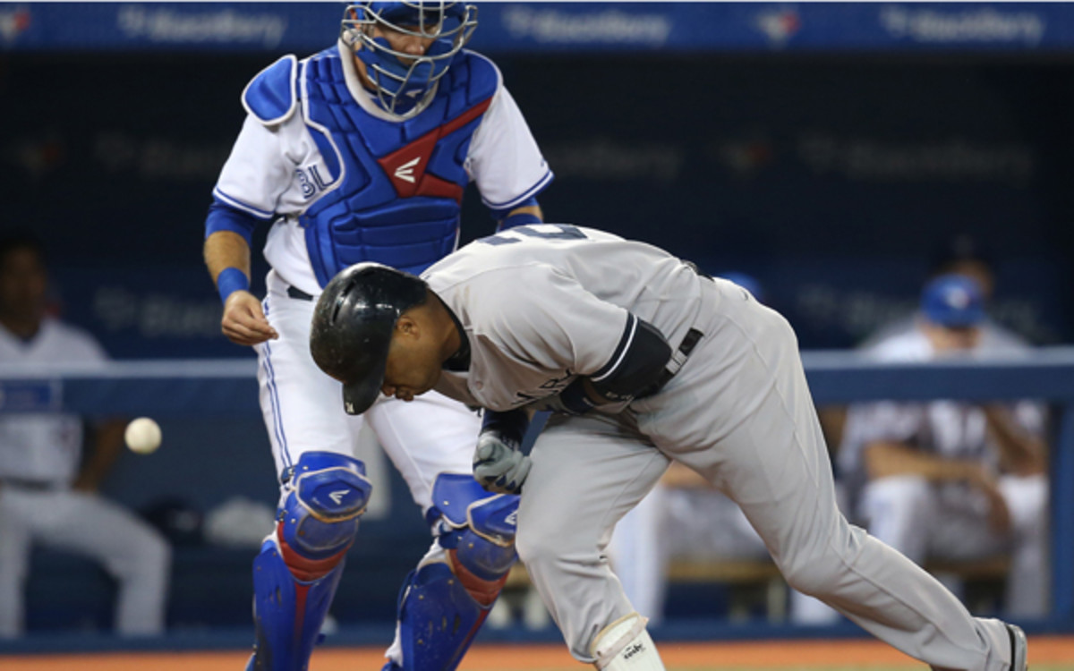 Yankees 2B Robinson Cano reacts after being hit by pitch. (Tom Szczerbowski/Getty Images)