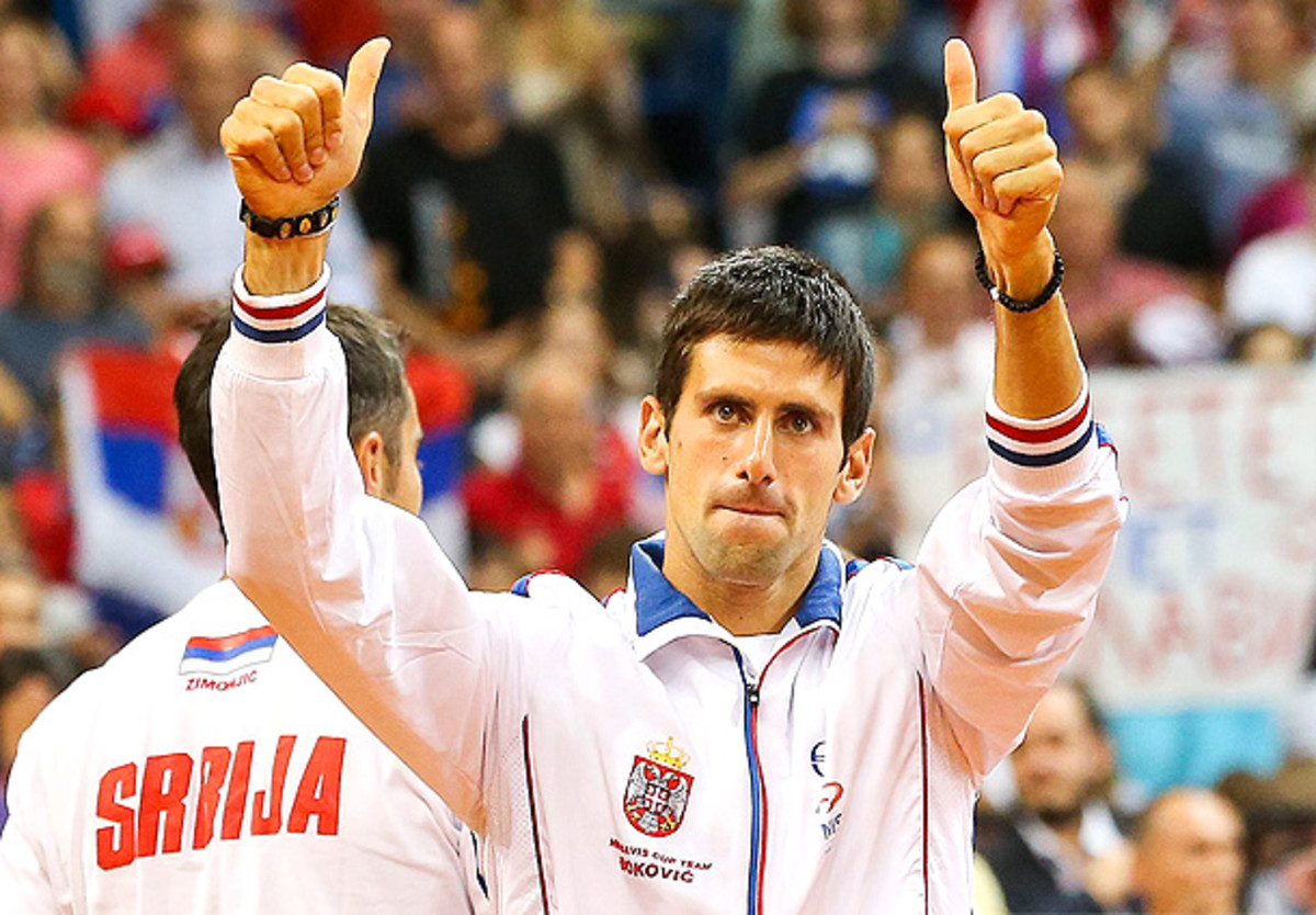 Novak Djokovic flashes a double thumbs up after Serbia defeats Canada in the Davis Cup World Group semifinal. (Srdjan Suki/EPA)