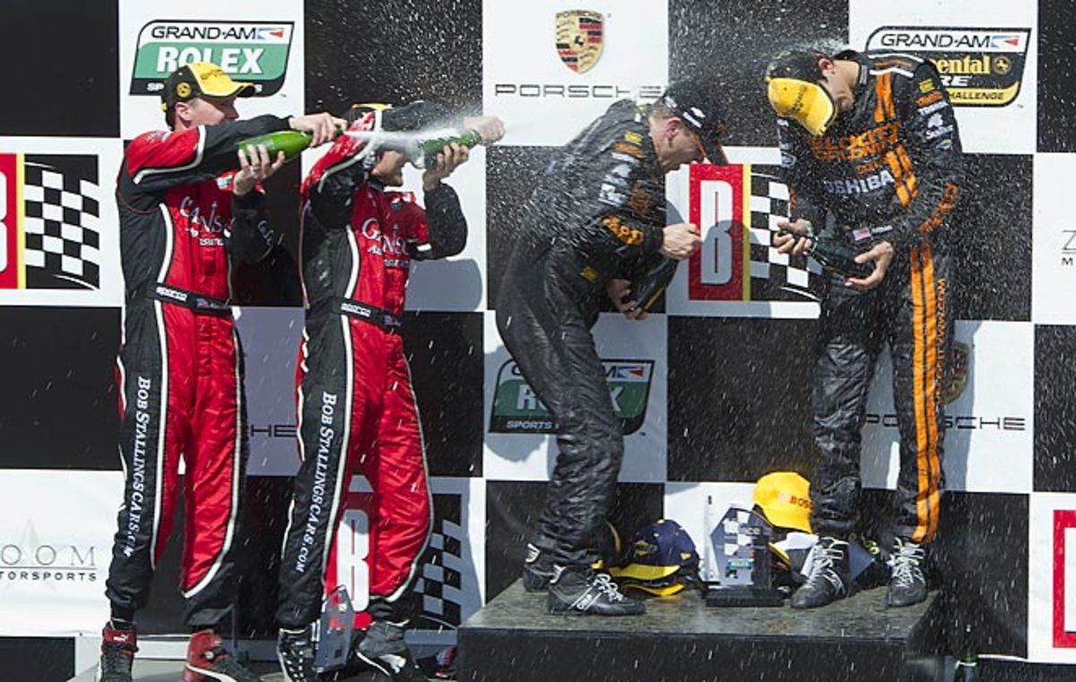 Max Angelelli and Jordan Taylor get a Champagne shower following their victory.
