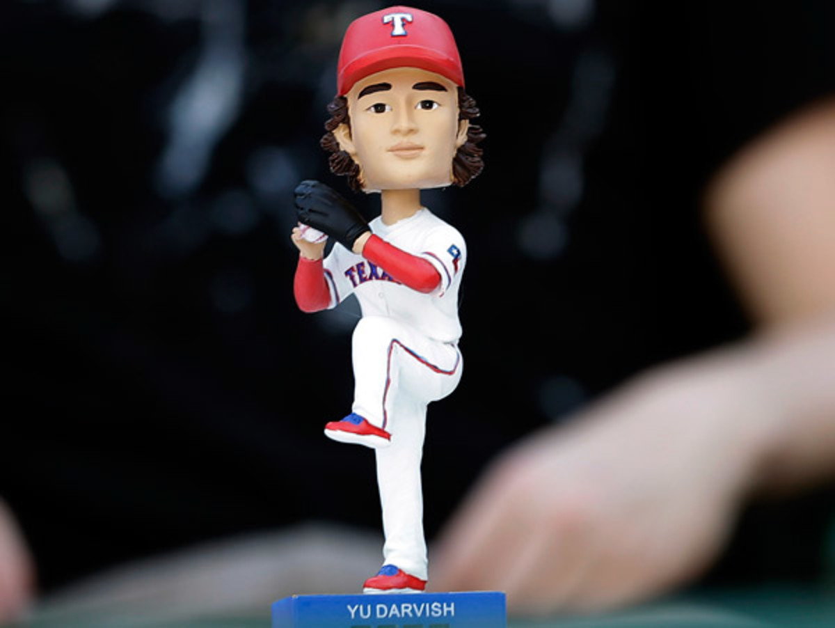 Fans at Thursday's Texas-Toronto game got a Yu Darvish bobblehead, complete with strikeout counter. (LM Otero/AP)