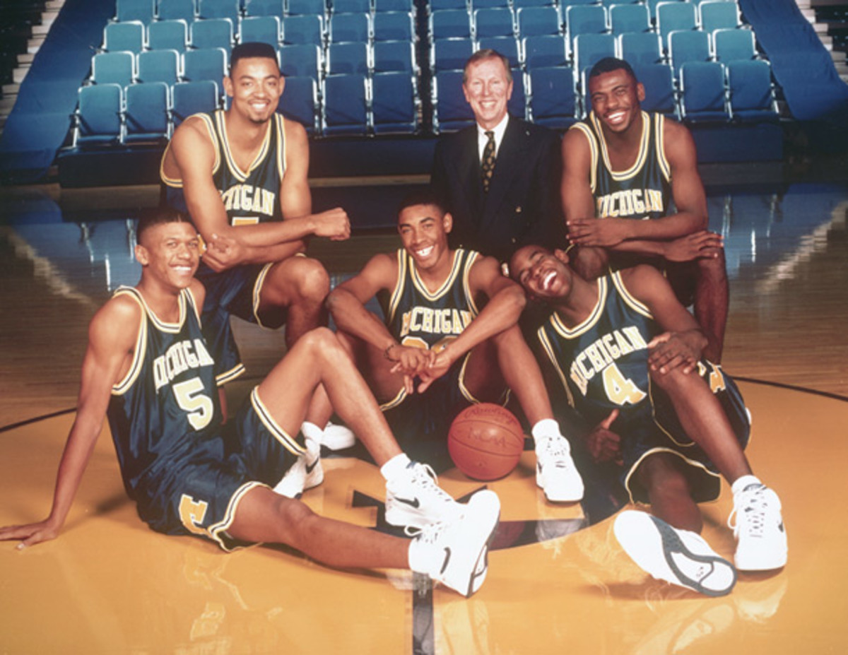 The Fab Five - Jalen Rose, Juwan Howard, Jimmy King, Chris Webber and Ray Jackson  - pose with coach Steve Fisher. (Courtesy of Michigan)