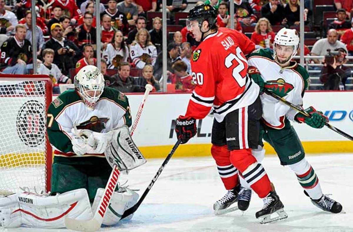 Brandon Saad and the Blackhawks struggled, but finally beat heroic Wild goalie Josh Harding.