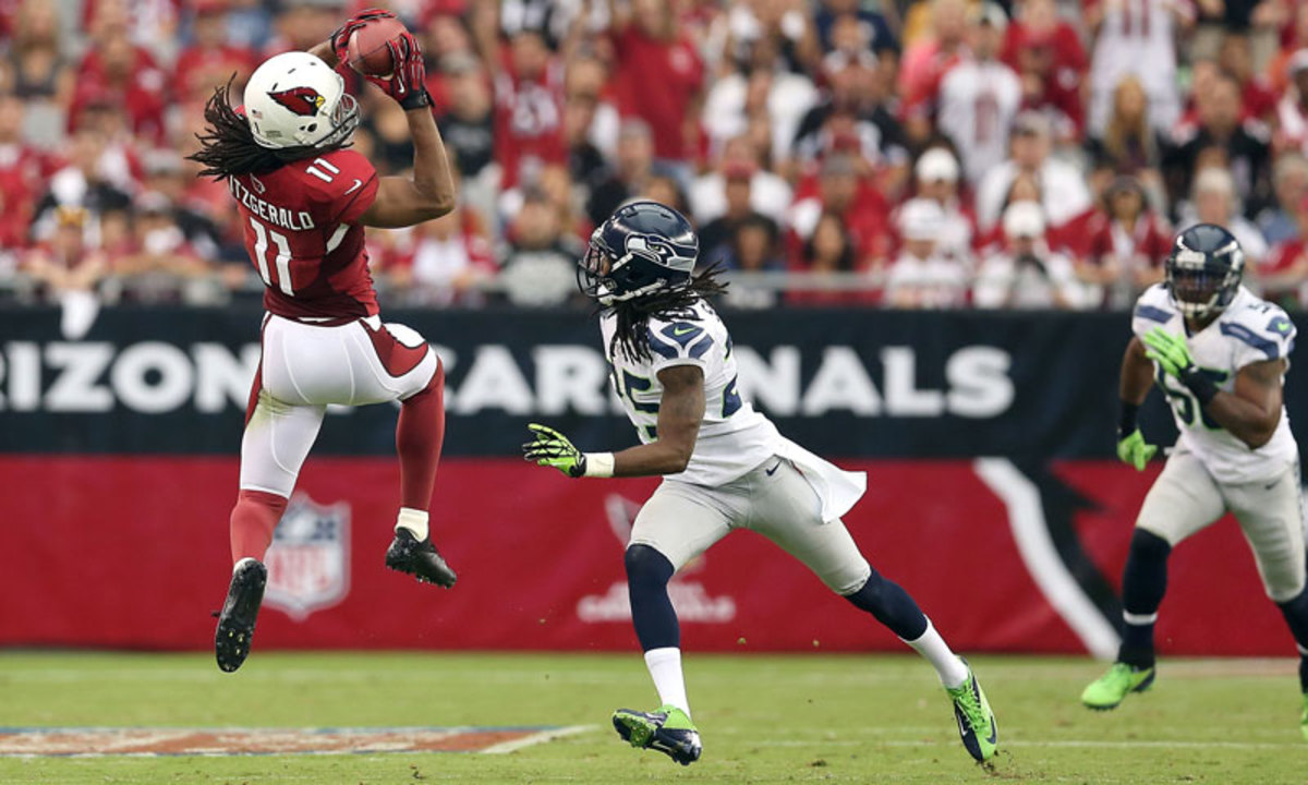 Richard Sherman (center) and the Seahawks defense were able to keep Larry Fitzgerald in check last season, allowing only five catches for 65 yards and no touchdowns in two games. (Christian Pedersen/Getty Images)