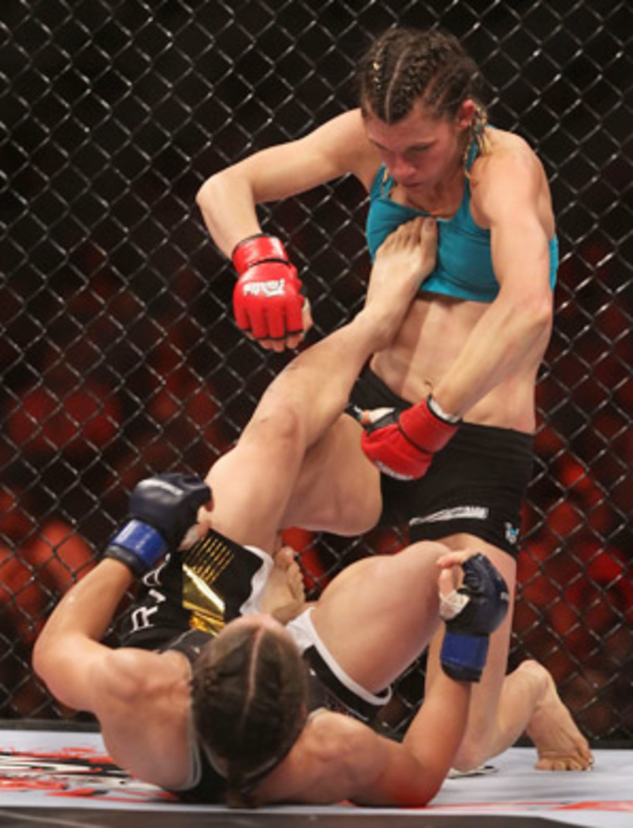 Liz Carmouche kicks her opponent Colleen Schneider in the chest during a 2010 bout.
