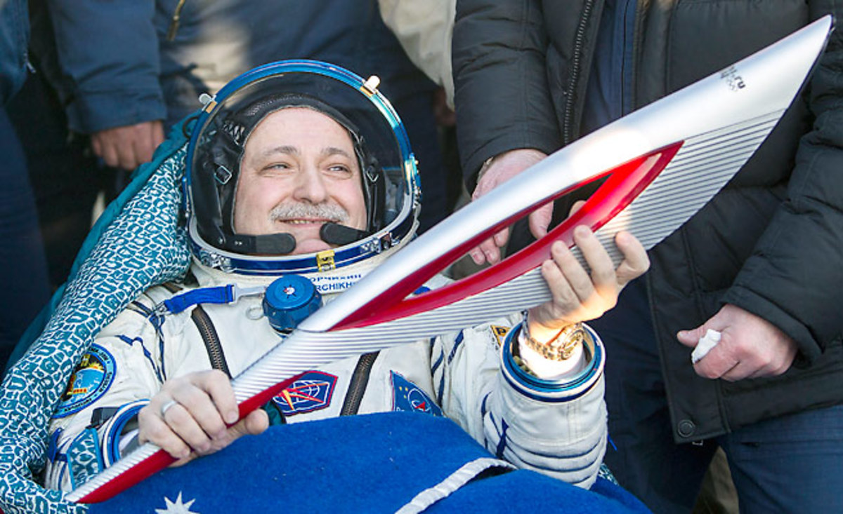 Fyodor Yurchikhin holds the Olympic torch after returning with it from the International Space Station.