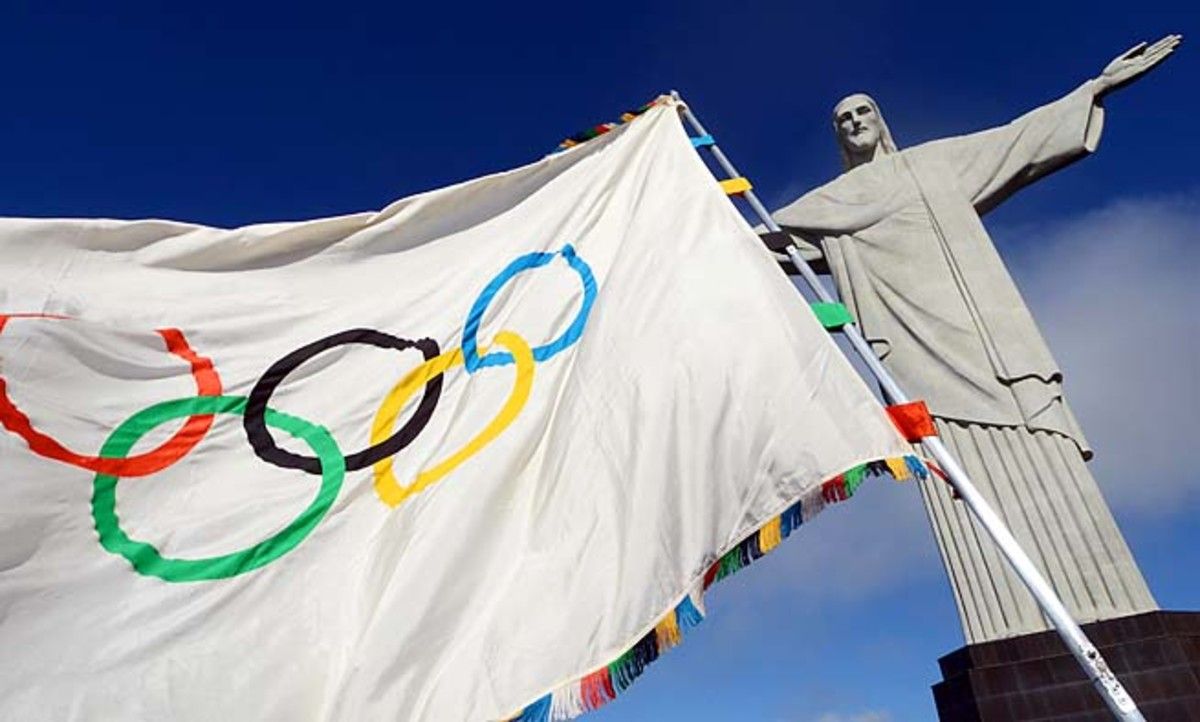The Olympic flag flies at the Christ the Redeemer statue in Rio de Janeiro.