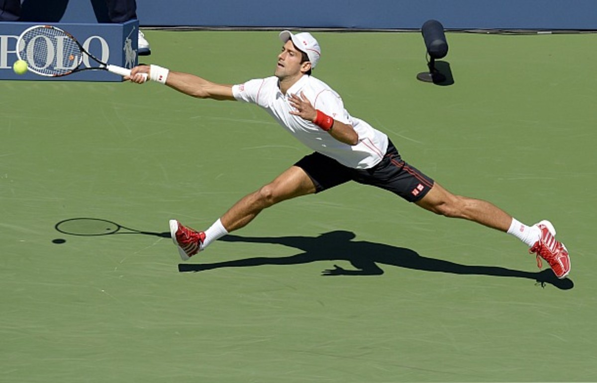 Djokovic shows off his famous flexibility. (Emmanuel Dunand/AFP/Getty Images)