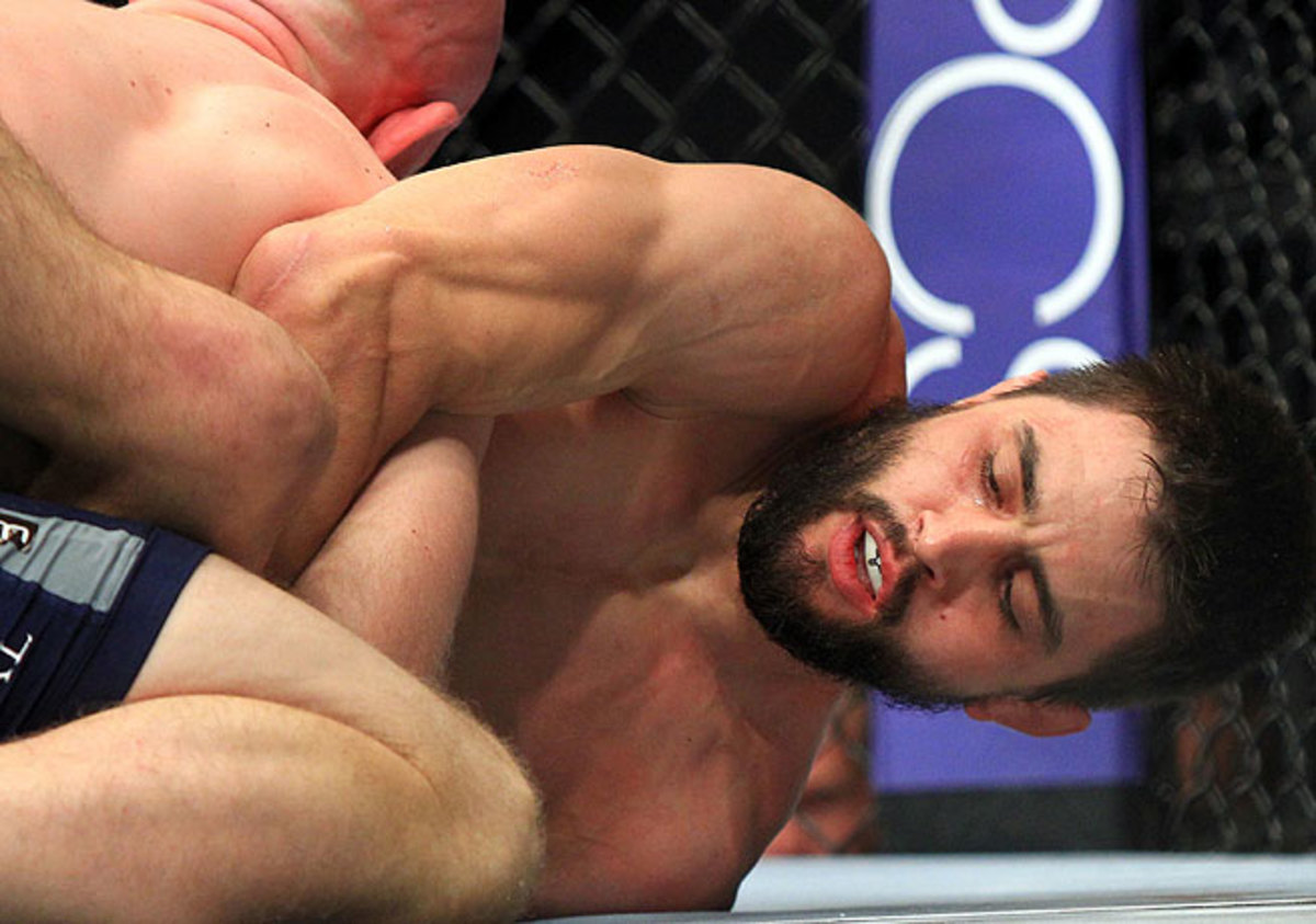 Carlos Condit (right) was down on the mat against Martin Kampmann early but fought back for the win.