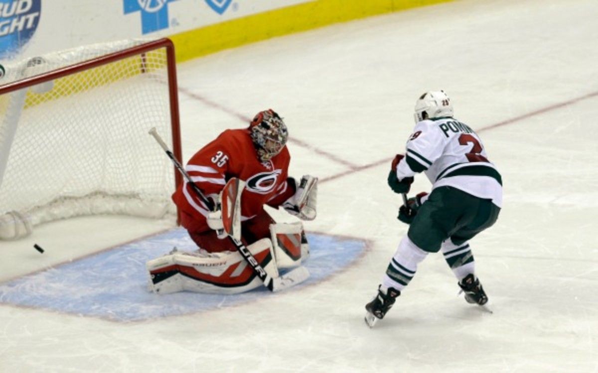 Wild's Jason Pominville scores against Hurricanes goalie Justin Peters (35) during a shootout. (AP Photo/Gerry Broome)
