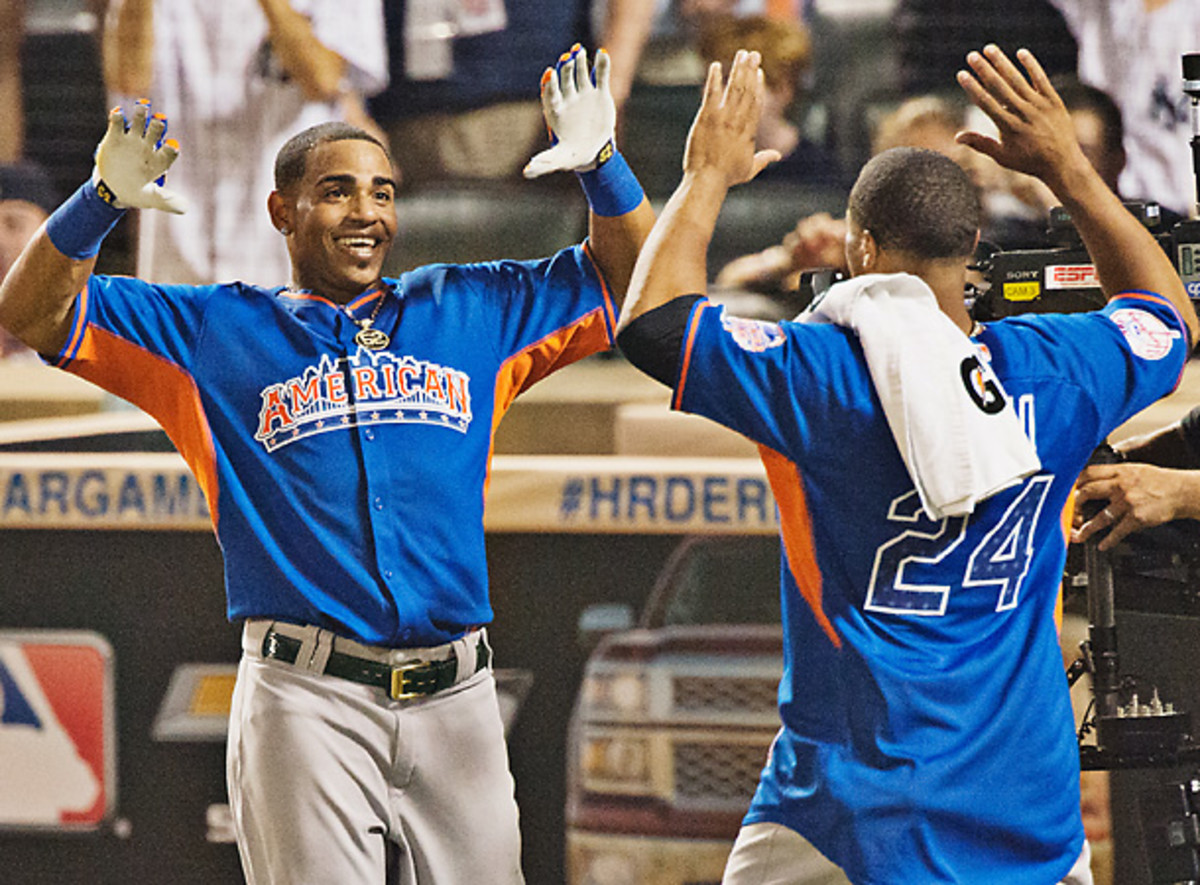 Yoenis Cespedes is congratulated by 2011 derby winner Robinson Cano after Cespedes' magnificent performance. [John Iacono/SI]