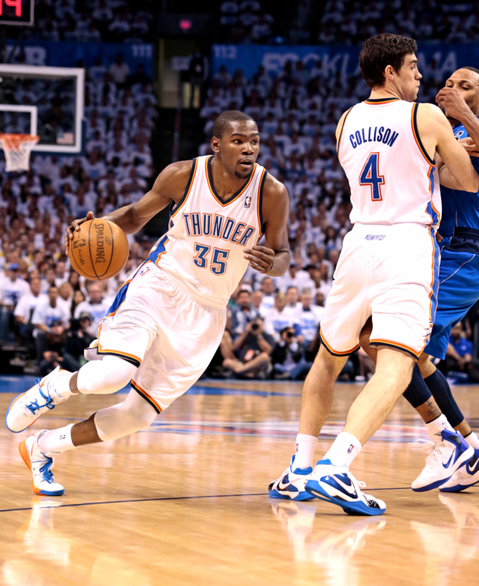 Kevin Durant works around a Nick Collison screen. (Brett Deering/Getty Images)