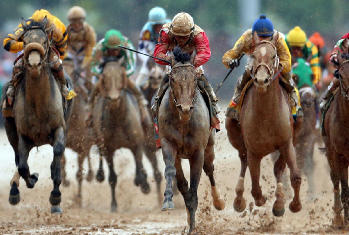Orb (center) took first in the Kentucky Derby, giving a win to jockey Joel Rosario and trainer Shug McGaughey.