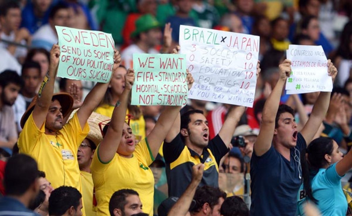 Fans hold up protest signs during a Confederations Cup match in Belo Horizonte.
