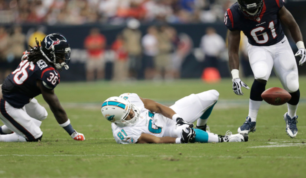 Dustin Keller grabs his knee after what looks to be a nasty injury against the Houston Texans. (Eric Gay/AP)