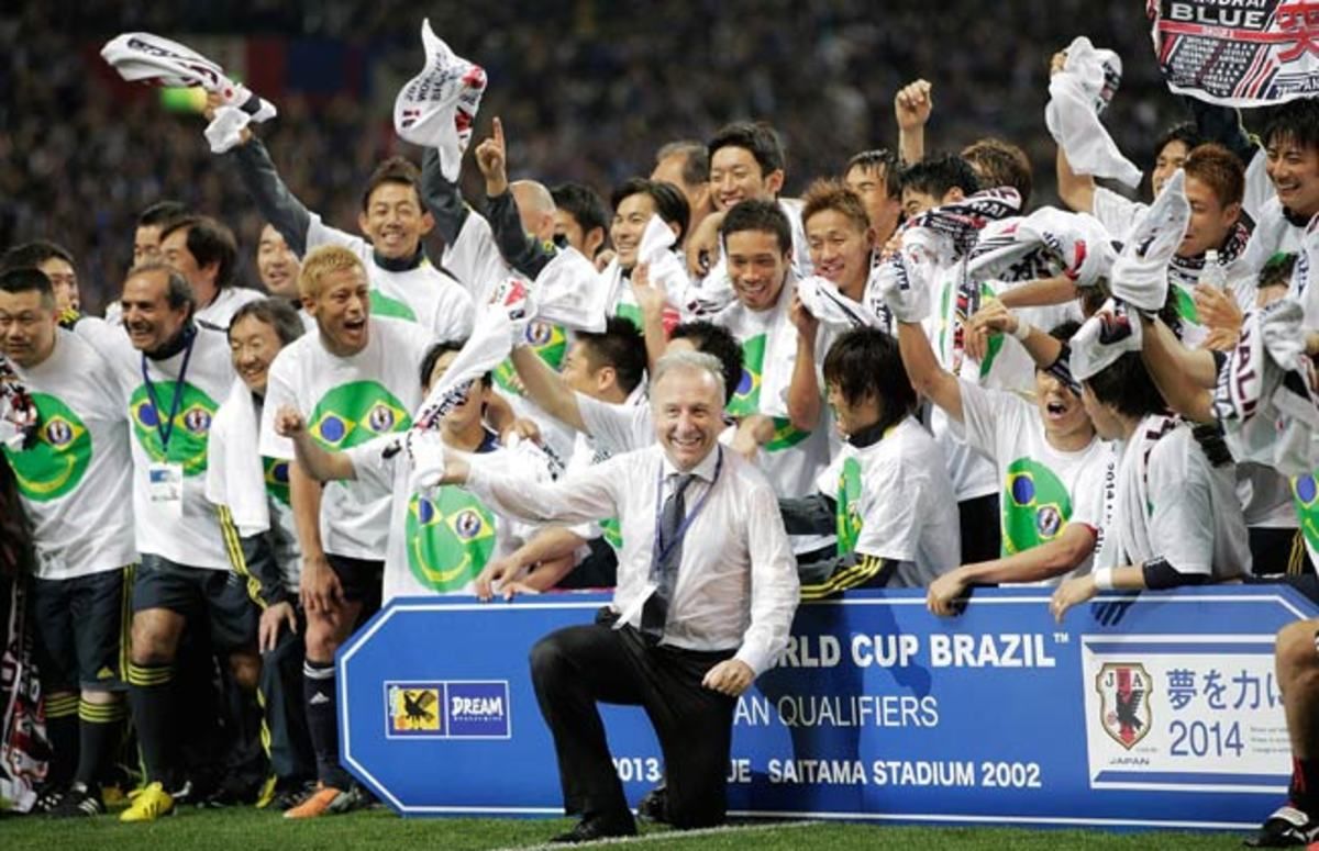 Japan's head coach Alberto Zaccheroni celebrates with his team after securing World Cup qualification