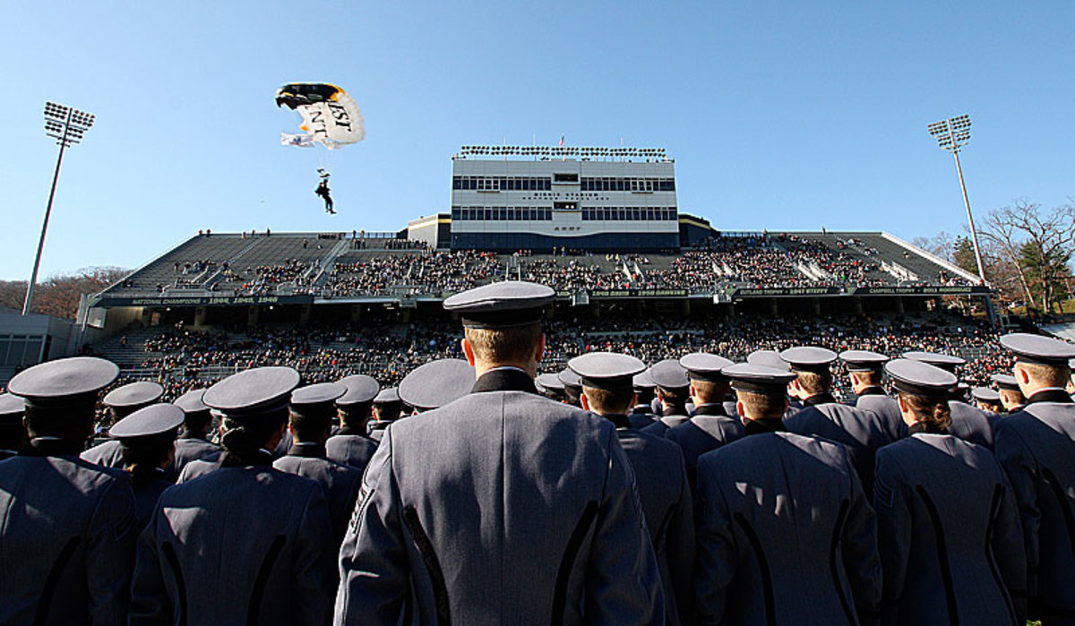 An Army parachute team brings the game ball onto the field at Michie Stadium.
