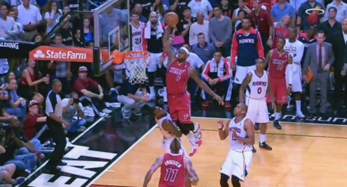 LeBron James dunks over Paul Millsap. (Sun Sports)