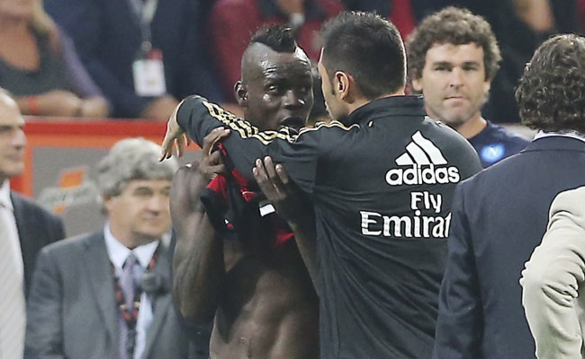 After receiving a second yellow card, Mario Balotelli was restrained by teammate Marco Amelia. 