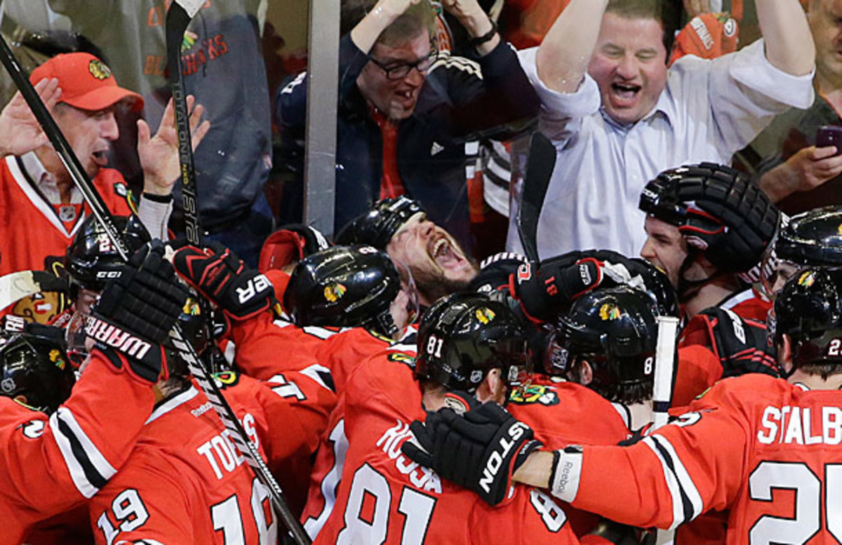 Brent Seabrook is mobbed by the Blackhawks after scoring the winning goal in Game 7 against the Red Wings