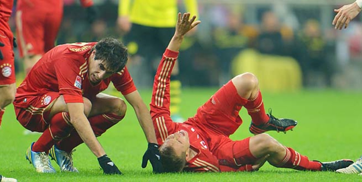 Bayern's Holger Badstuber lies injured during a match with Dortmund in December.