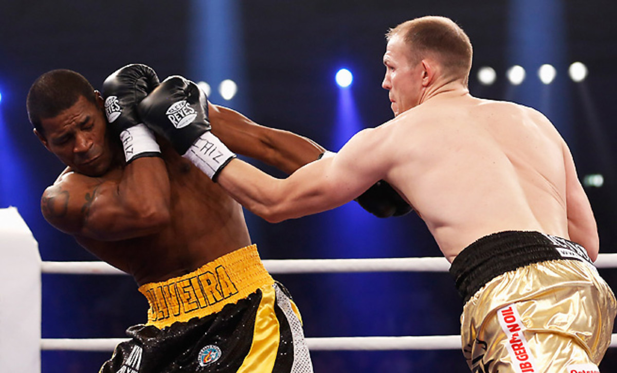 Juergen Braehmer battered Marcus Oliveira to take the vacant WBA world light heavyweight title.