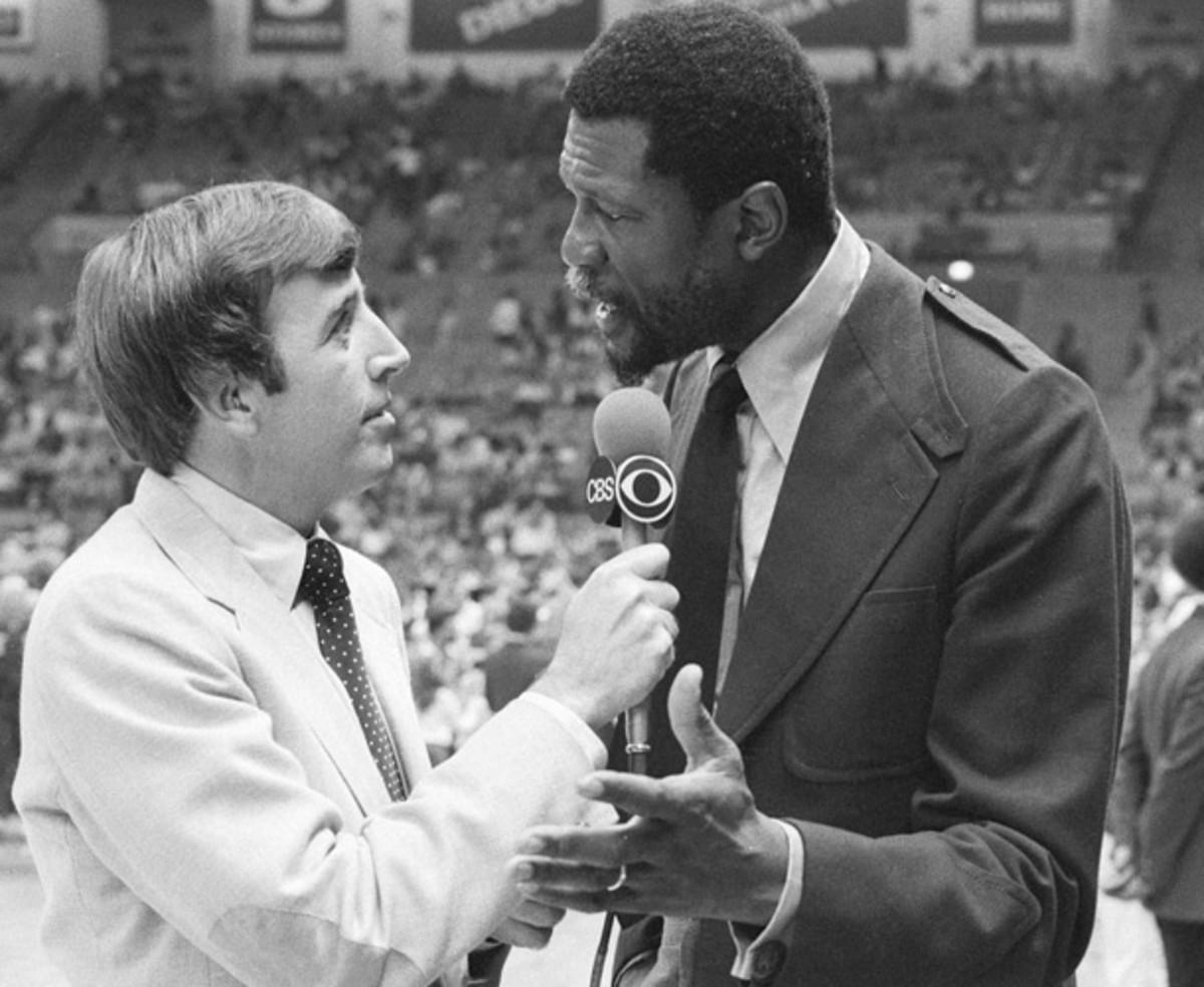 Musburger talks with basketball legend Bill Russell before an NBA game in 1980. (CBS Photo Archive)