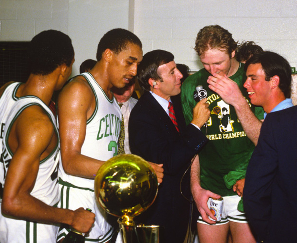 Musburger interviews Larry Bird amid a crowd of Celtics players after Boston beat the Los Angeles Lakers in Game 7 of the 1984 NBA Finals. (Focus on Sport/Getty Images)
