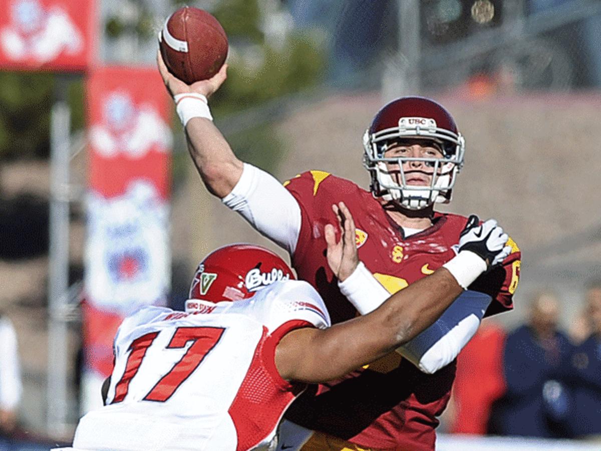 Cody Kessler (right) was magnificent against Fresno State, throwing for 342 yards and four TDs. (David Cleveland/AP)