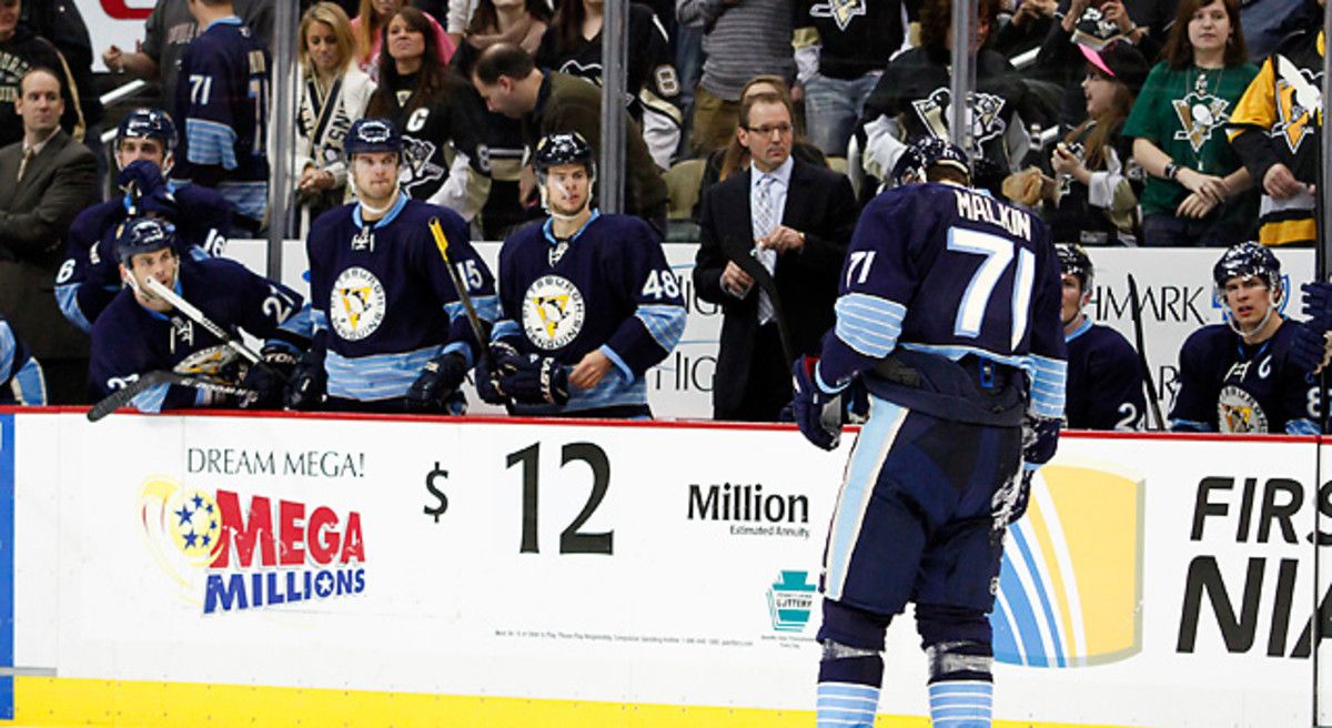 Evgeni Malkin skates gingerly after absorbing a huge hit from Florida's Erik Gudbranson. [Justin K. Aller/Getty Images]