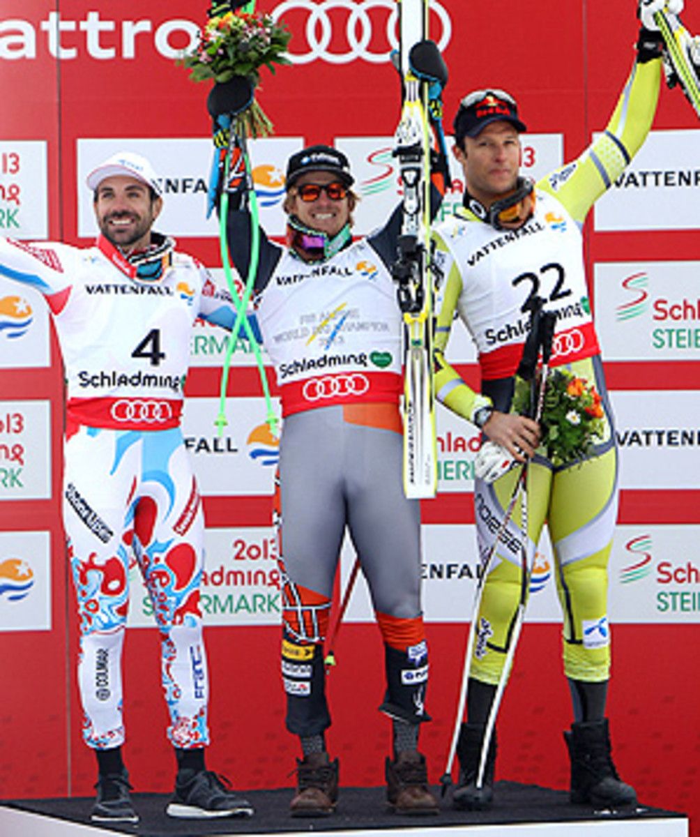 Ted Ligety celebrates his super-G world title on the podium, flanked by Gauthier De Tessieres of France (second) and Aksel Lund Svindal of Norway (third).