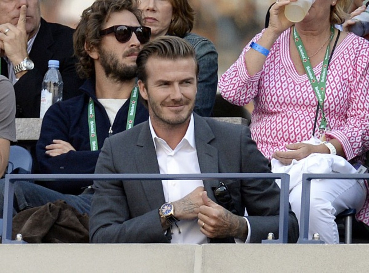 David Beckham finds his seat for the men's final. (Timothy Clary/AFP/Getty Images)