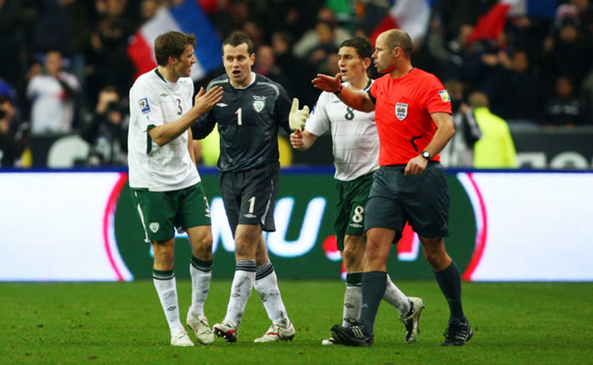 Ireland players protest to referee Martin Hansson after he allowed a goal that resulted from a handball by Thierry Henry.
