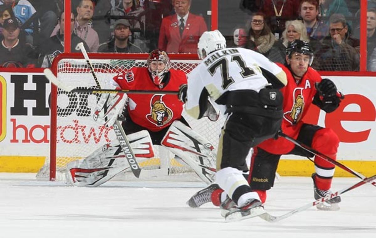Craig Anderson of the Ottawa Senators and Evgeni Malkin of the Pittsburgh Penguins