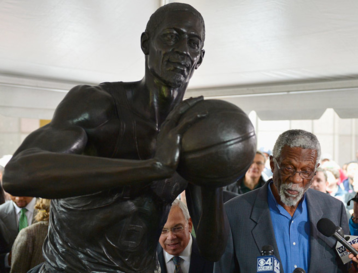 Celtics great Bill Russell speaks with reporters next to a 600-pound bronze statue in his honor.