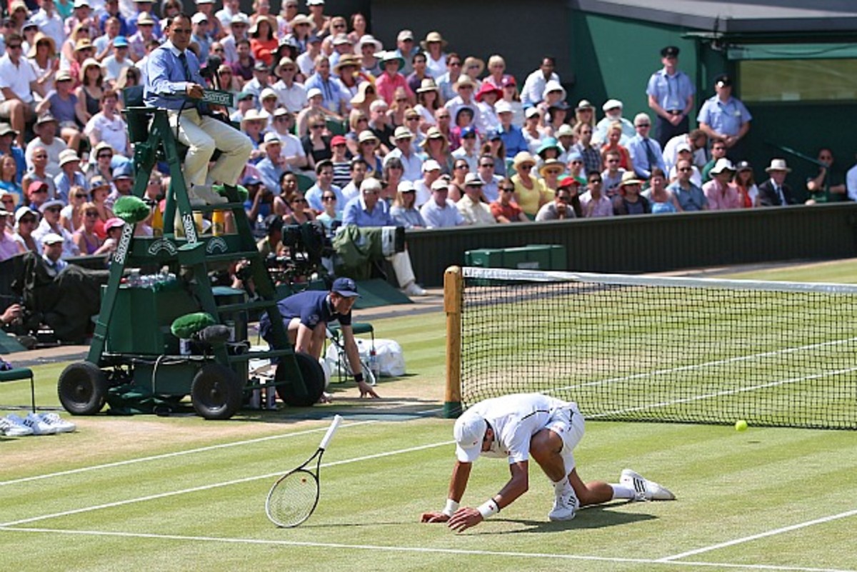 Novak Djokovic takes a fall in the first set. (Julian Finney/Getty Images)
