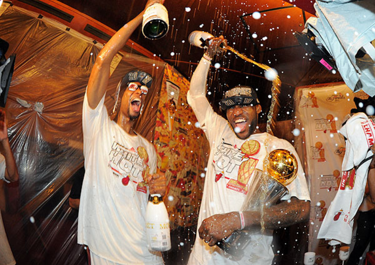 Miami Heat's LeBron James (right) and Chris Bosh brought out the champagne after winning the 2012-13 title. 