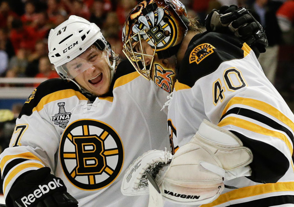 Torey Krug (left) and Tuukka Rask celebrate after Boston's 2-1 overtime win in Game 2 on Saturday.