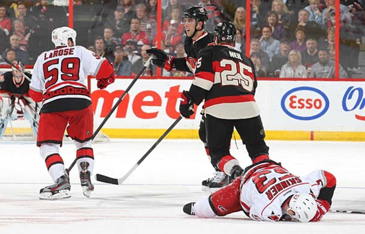 Jeff Skinner of the Hurricanes lies on the ice after being knocked senseless.