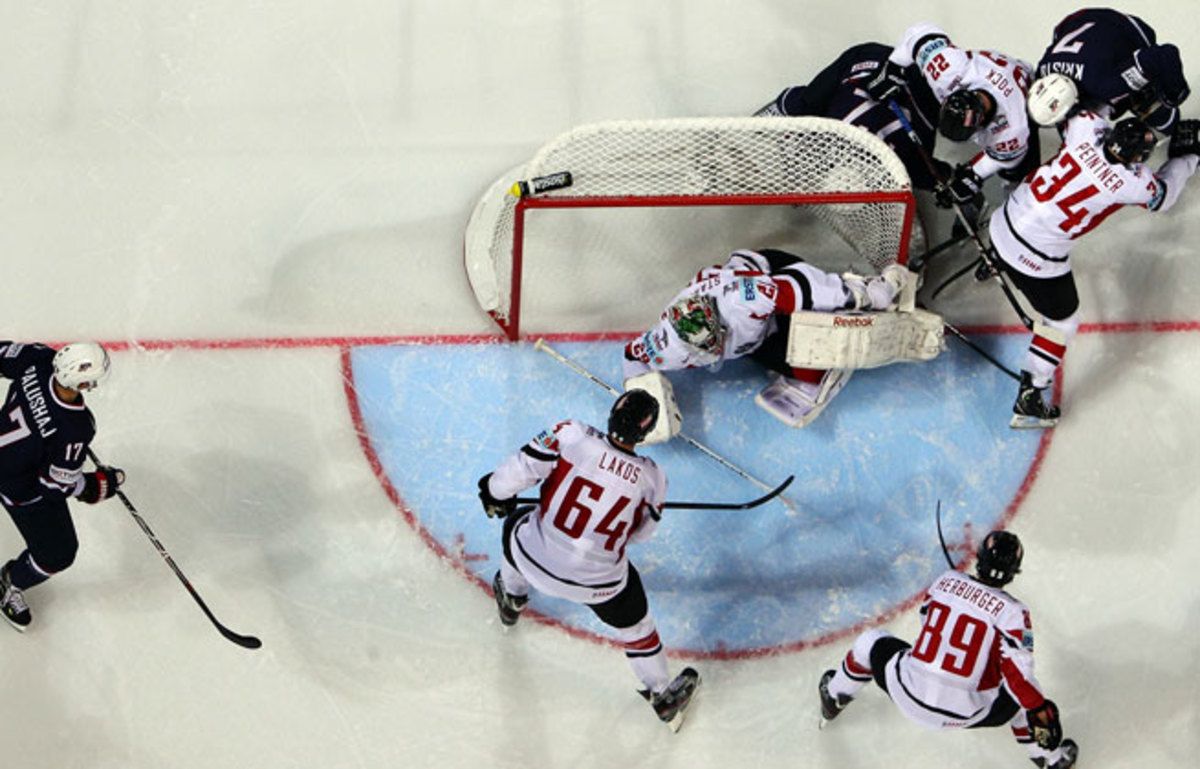 The U.S. (in blue) rallied from down 2-0 to beat Austria 5-3 in its opening game at the ice hockey world championship.